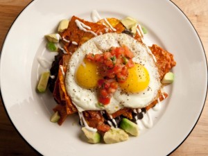 Chilaquiles rojos (triangle sliced and fried tortilla with red salsa)